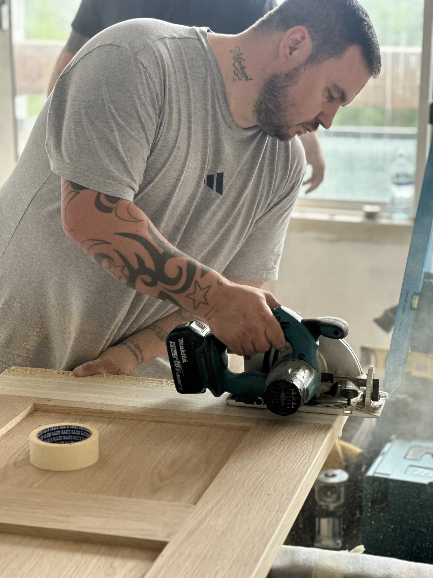 Trovix joiner trimming a new oak door on site in the Battersea flat