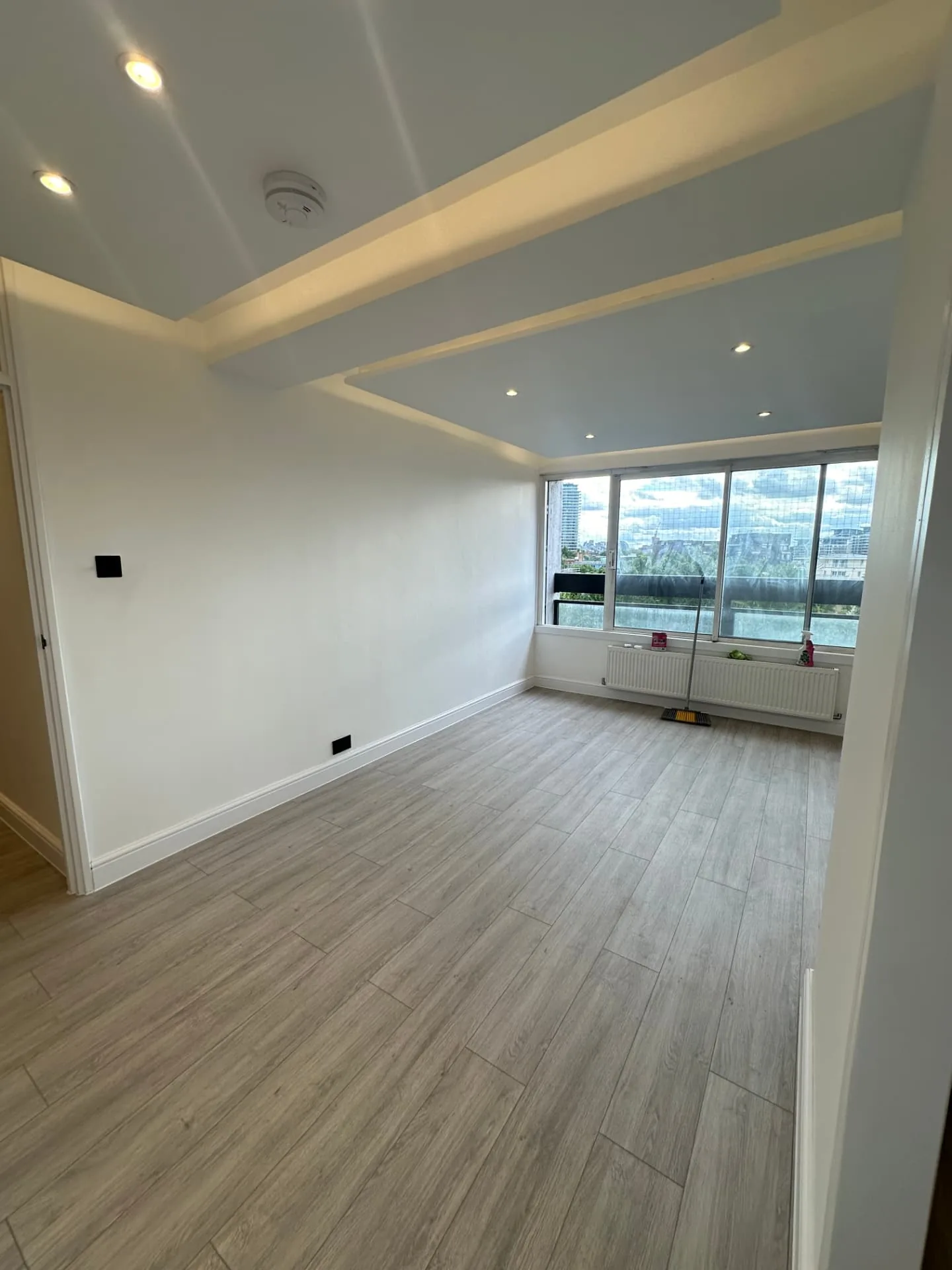 Completed lounge with new flooring and recessed ceiling lighting