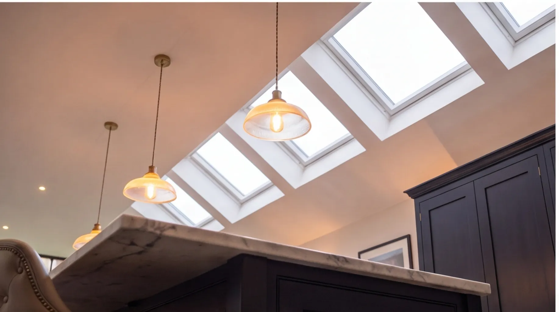 Side return extension in London with rooflights, pendant lighting and a kitchen island